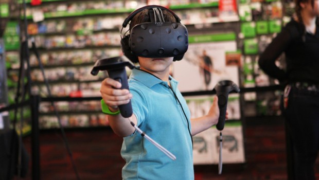 A kid playing with the HTC Vive headset